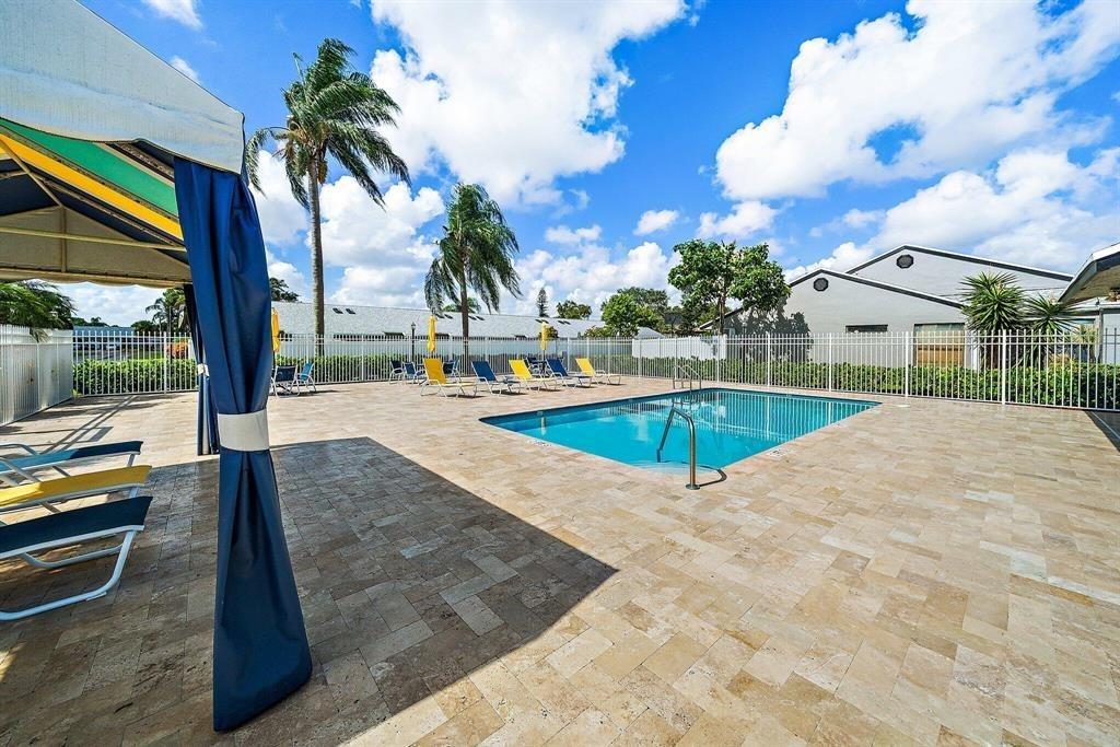 4519 Feivel Road, Unit 46 West Palm Beach, FL 33417 - Photo 48 of 56 a view of a backyard patio and swimming pool
