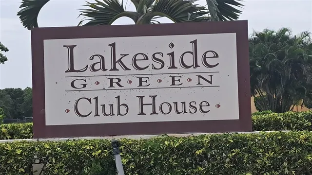 a view of a workspace with furniture and bookshelf