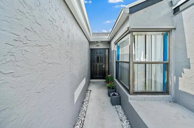a kitchen with stainless steel appliances granite countertop a refrigerator a stove and a wooden floors