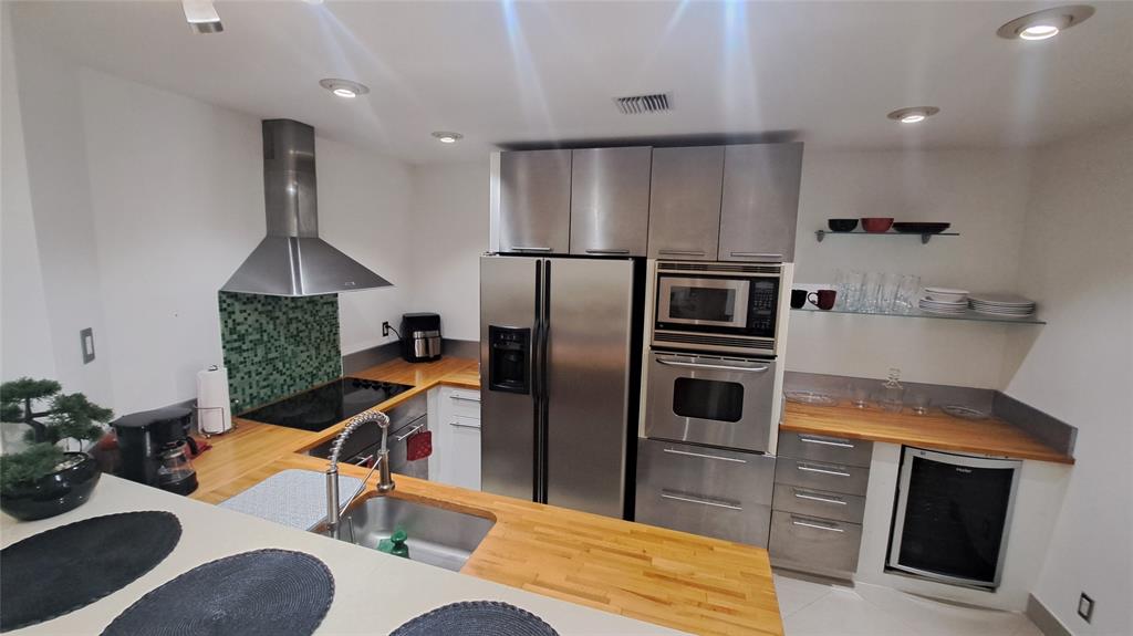 4519 Feivel Road, Unit 46 West Palm Beach, FL 33417 - Photo 9 of 56 a kitchen with stainless steel appliances granite countertop a refrigerator a stove and a wooden floors
