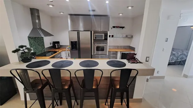 a kitchen with a sink appliances and cabinets