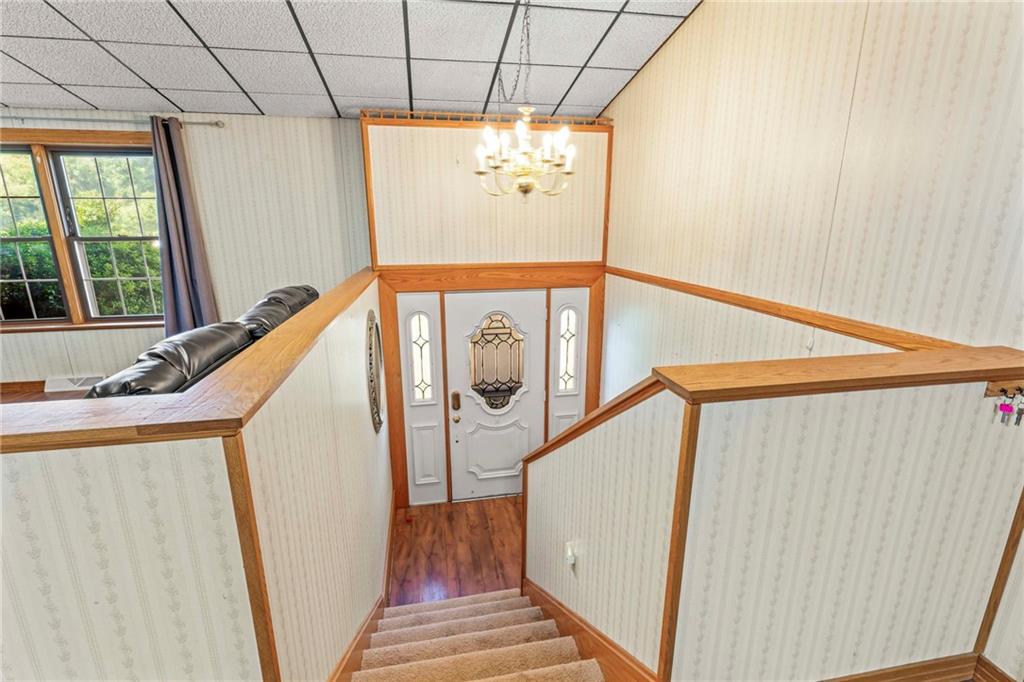218 Gwynn Road Jefferson, PA 15344 - Photo 13 of 32 a view of a hallway with wooden floor and staircase