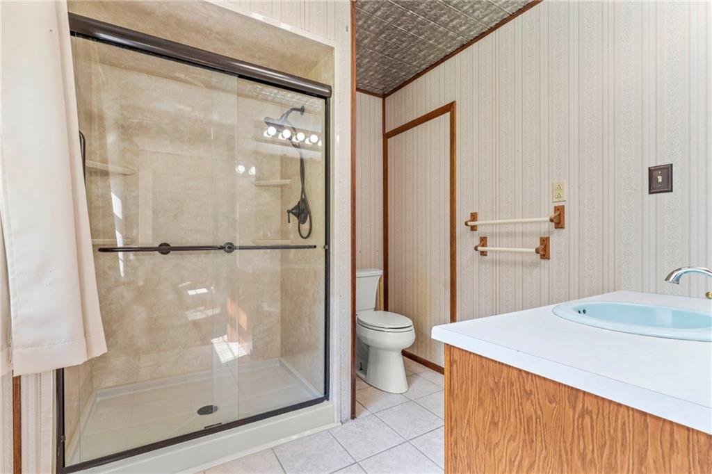 218 Gwynn Road Jefferson, PA 15344 - Photo 26 of 32 a bathroom with a granite countertop sink mirror and toilet