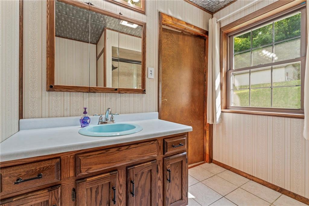 218 Gwynn Road Jefferson, PA 15344 - Photo 27 of 32 a bathroom with a sink a vanity and a mirror