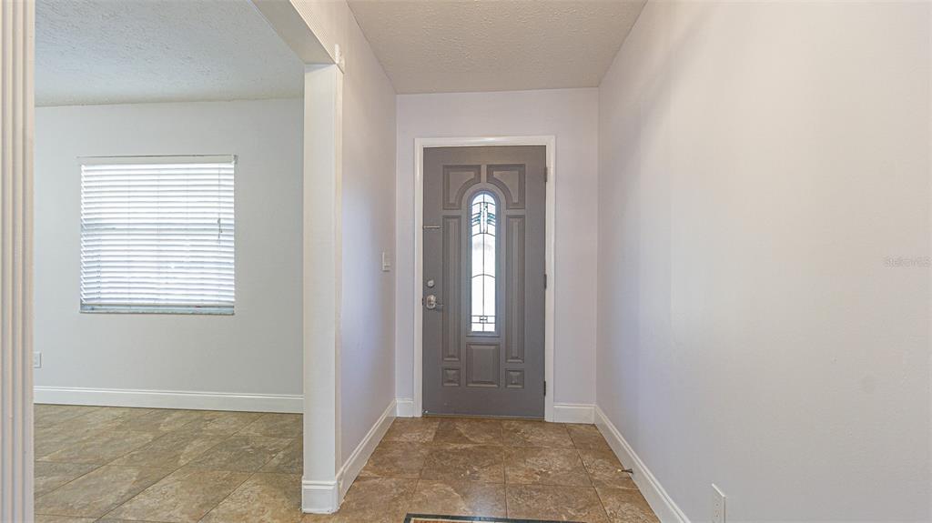 3801 Durant Road Valrico, FL 33596 - Photo 23 of 53 a view of a hallway with wooden floor and a window