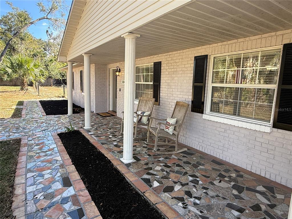 3801 Durant Road Valrico, FL 33596 - Photo 28 of 53 a view of a patio with table and chairs and wooden floor