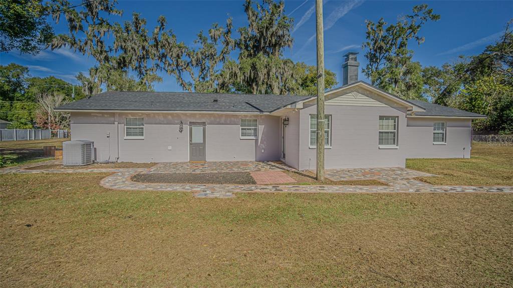 3801 Durant Road Valrico, FL 33596 - Photo 37 of 53 a view of a white house next to a yard and palm trees