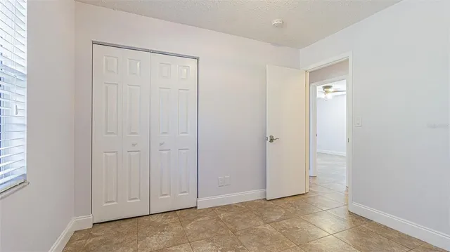 a view of an empty room with a kitchen