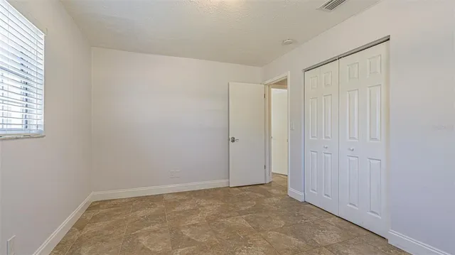 a kitchen with stainless steel appliances granite countertop a stove top oven a sink dishwasher a refrigerator and white cabinets with wooden floor