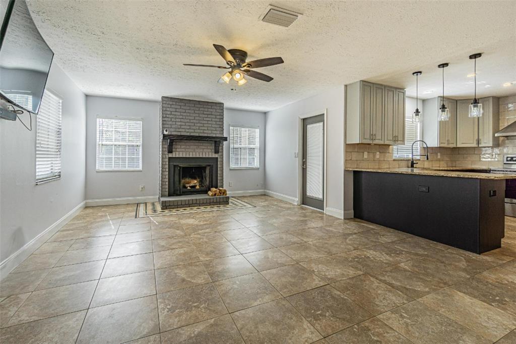 3801 Durant Road Valrico, FL 33596 - Photo 5 of 56 a view of an empty room with a fireplace and a window