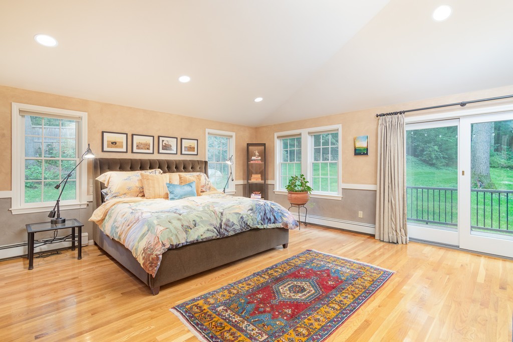95 Pine Street Medfield, MA 02052 - Photo 12 of 30 a bedroom with a large bed and a lamp next to a window