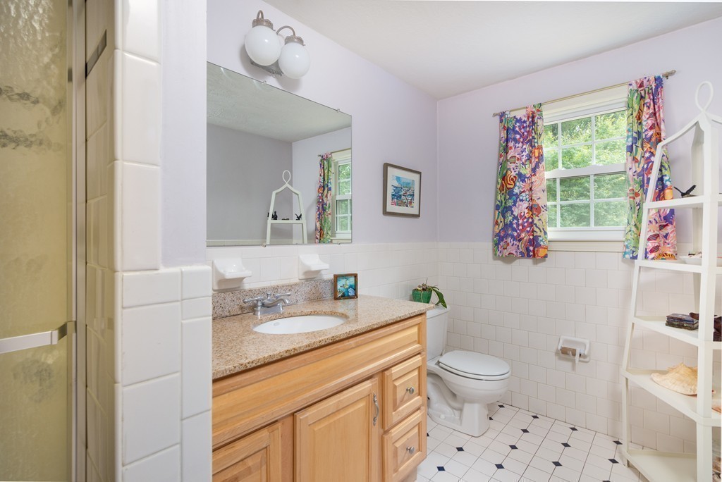 95 Pine Street Medfield, MA 02052 - Photo 22 of 30 a bathroom with a sink a toilet and a mirror