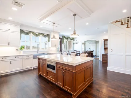 a large white kitchen with a lot of counter space