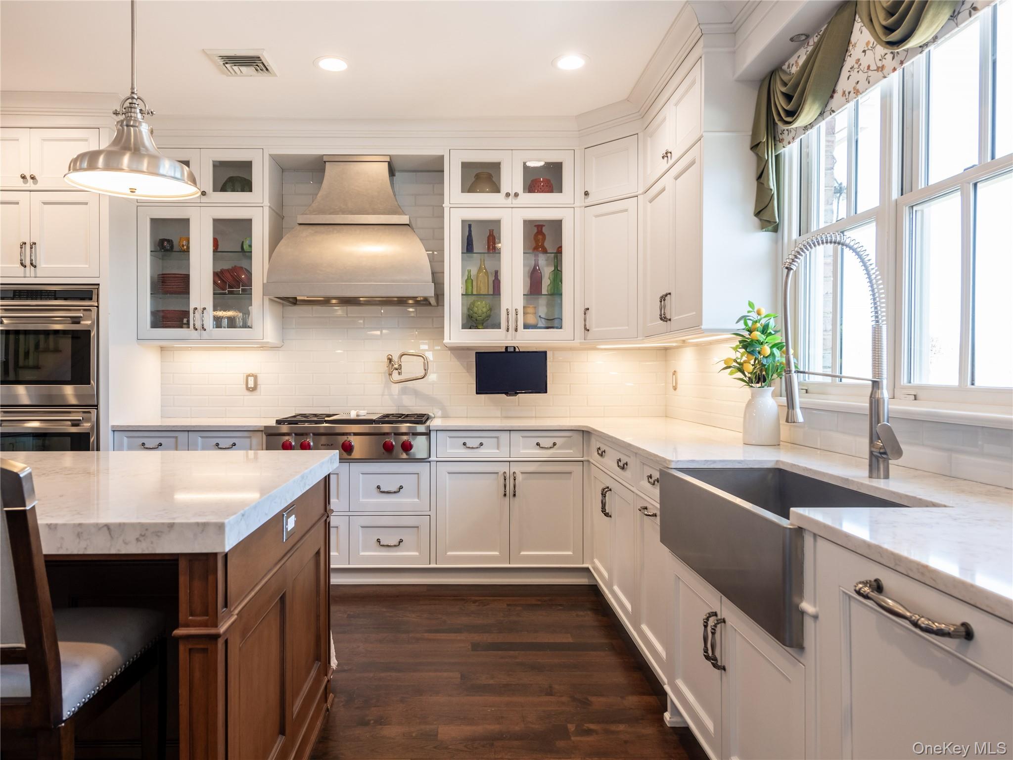 27 True Harbour Way West Islip, NY 11795 - Photo 13 of 26 a kitchen with a sink stove and cabinets
