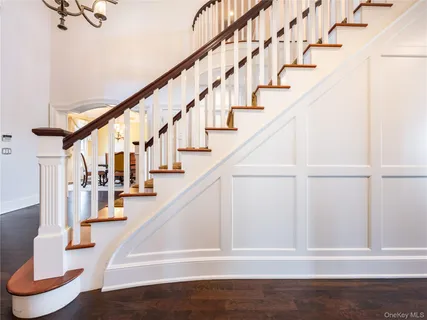 a view of entryway and hall with wooden floor