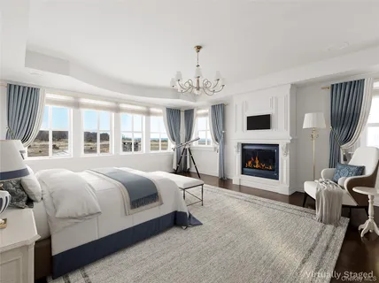 a spacious bedroom with a bed and a fireplace