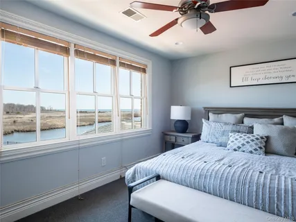 a bedroom with a large bed and a window