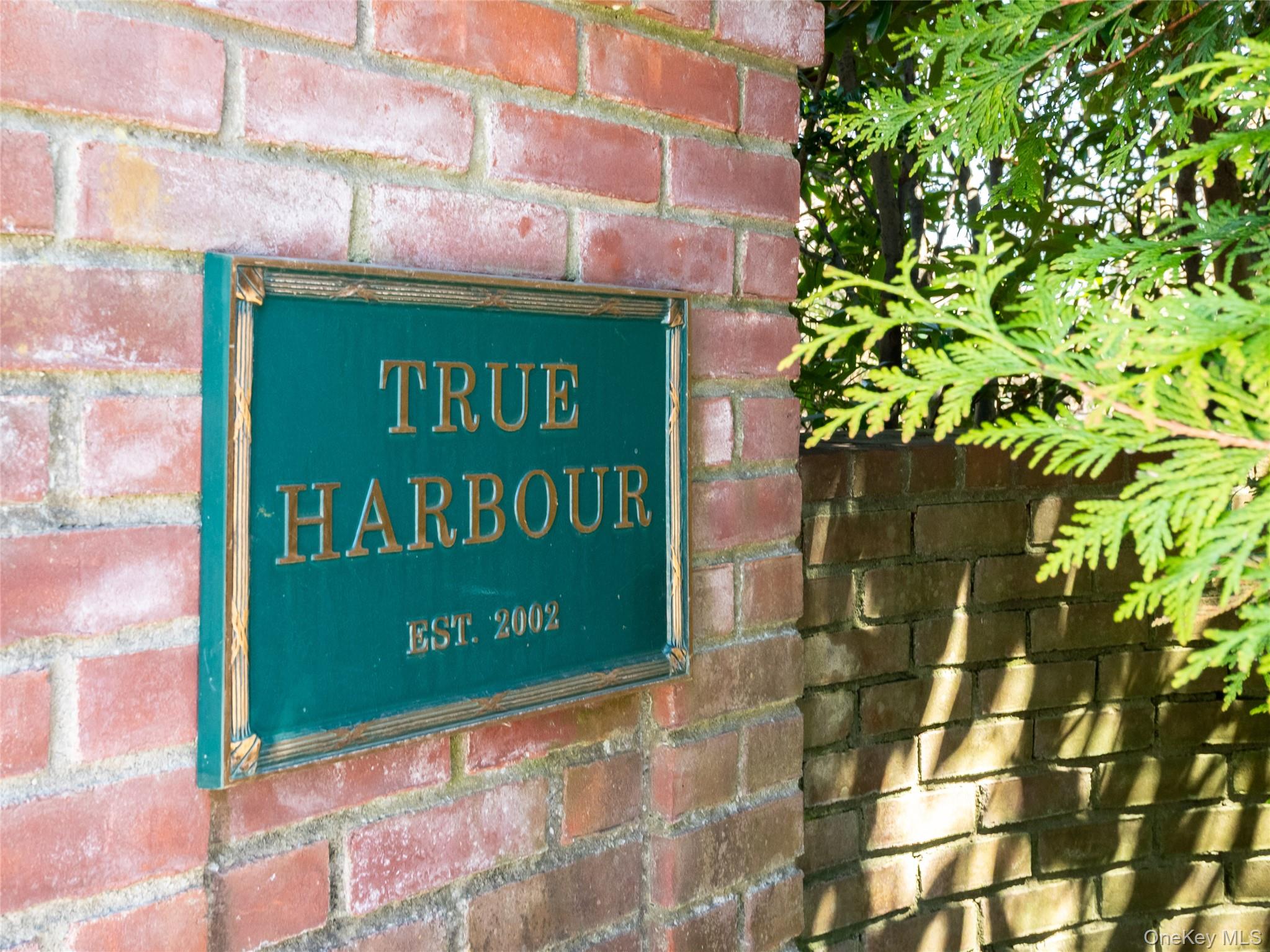 27 True Harbour Way West Islip, NY 11795 - Photo 2 of 26 a sign on the side of a building