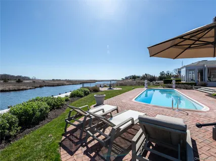 an aerial view of a house with swimming pool and patio