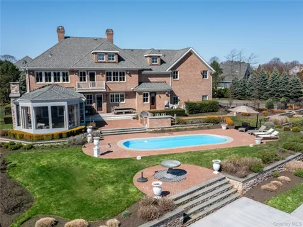 a front view of house with yard and swimming pool