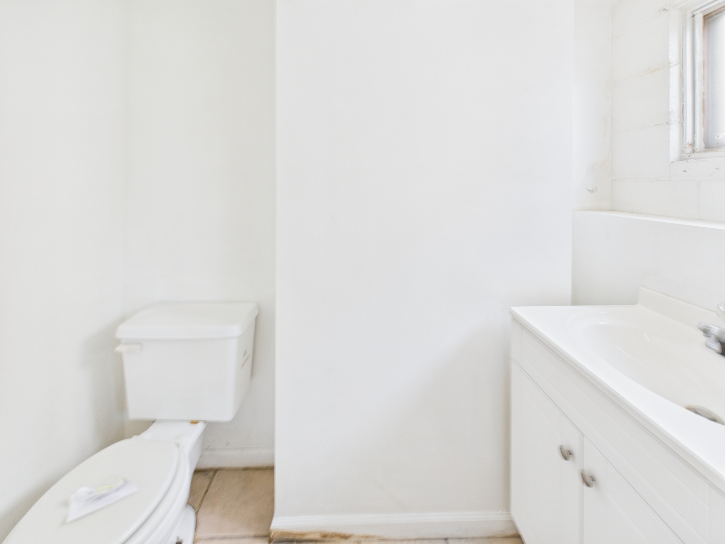 235 32nd Avenue Bellwood, IL 60104 - Photo 20 of 24 a bathroom with a sink a toilet and a window