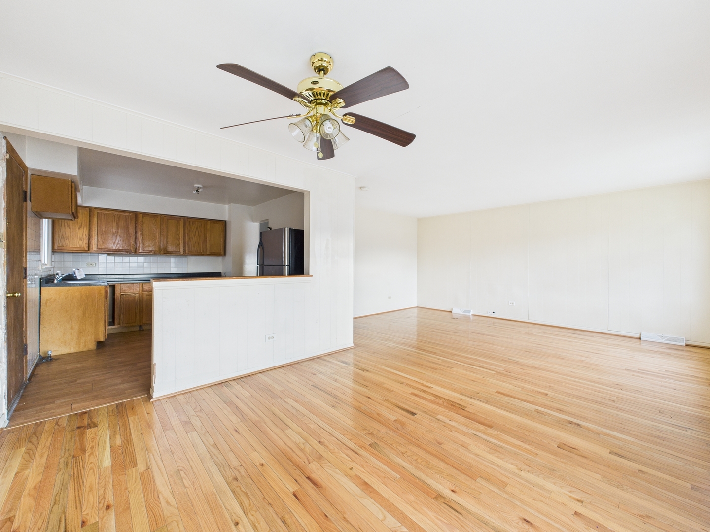 235 32nd Avenue Bellwood, IL 60104 - Photo 6 of 24 a view of a kitchen with microwave and a ceiling fan