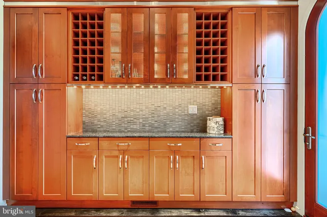 view of door with wooden walls