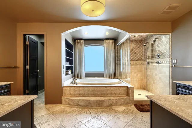 a bathroom with a granite countertop sink a toilet and shower