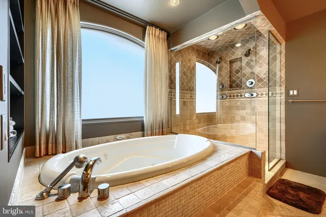 a bathroom with a tub and a shower