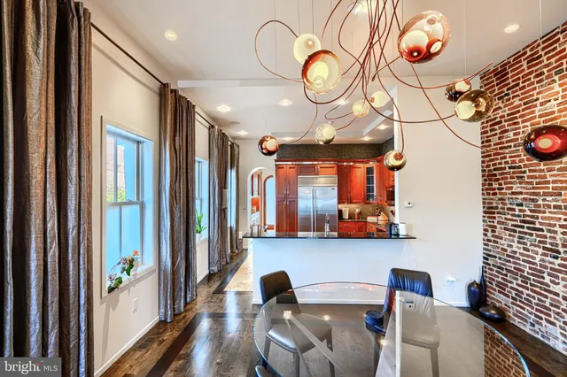 a view of a dining room with furniture and chandelier fan