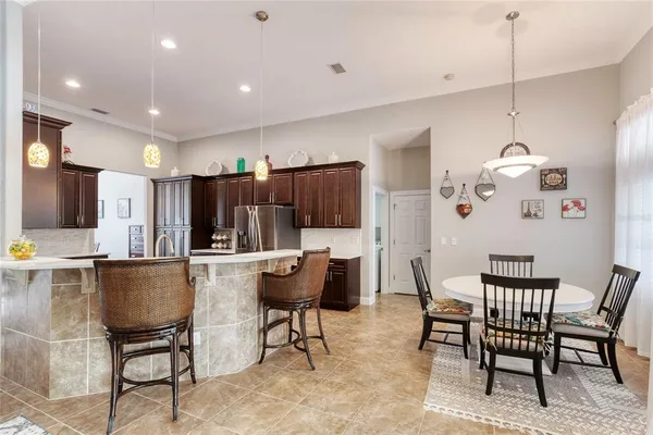 a living room with furniture a flat screen tv and a floor to ceiling window