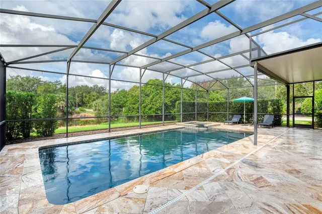 an aerial view of a house with a yard and lake view