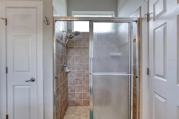 a view of a house with a big yard and large trees