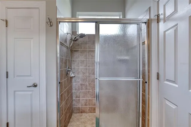 a view of a house with a big yard and large trees