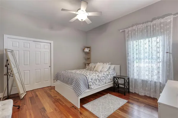 a view of a house with a big yard and large trees