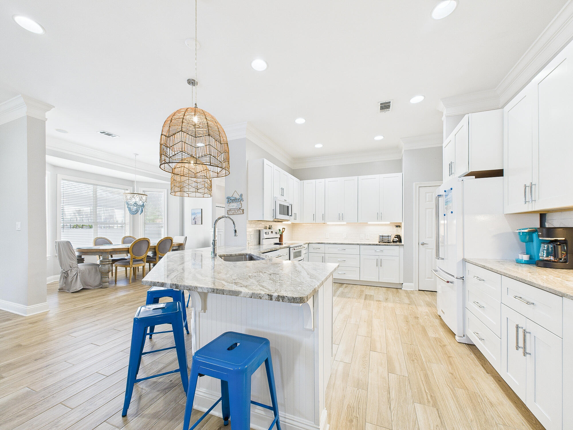 4634 Sunset Pointe Destin, FL 32541 - Photo 13 of 68 a large kitchen with stainless steel appliances kitchen island granite countertop a sink and cabinets