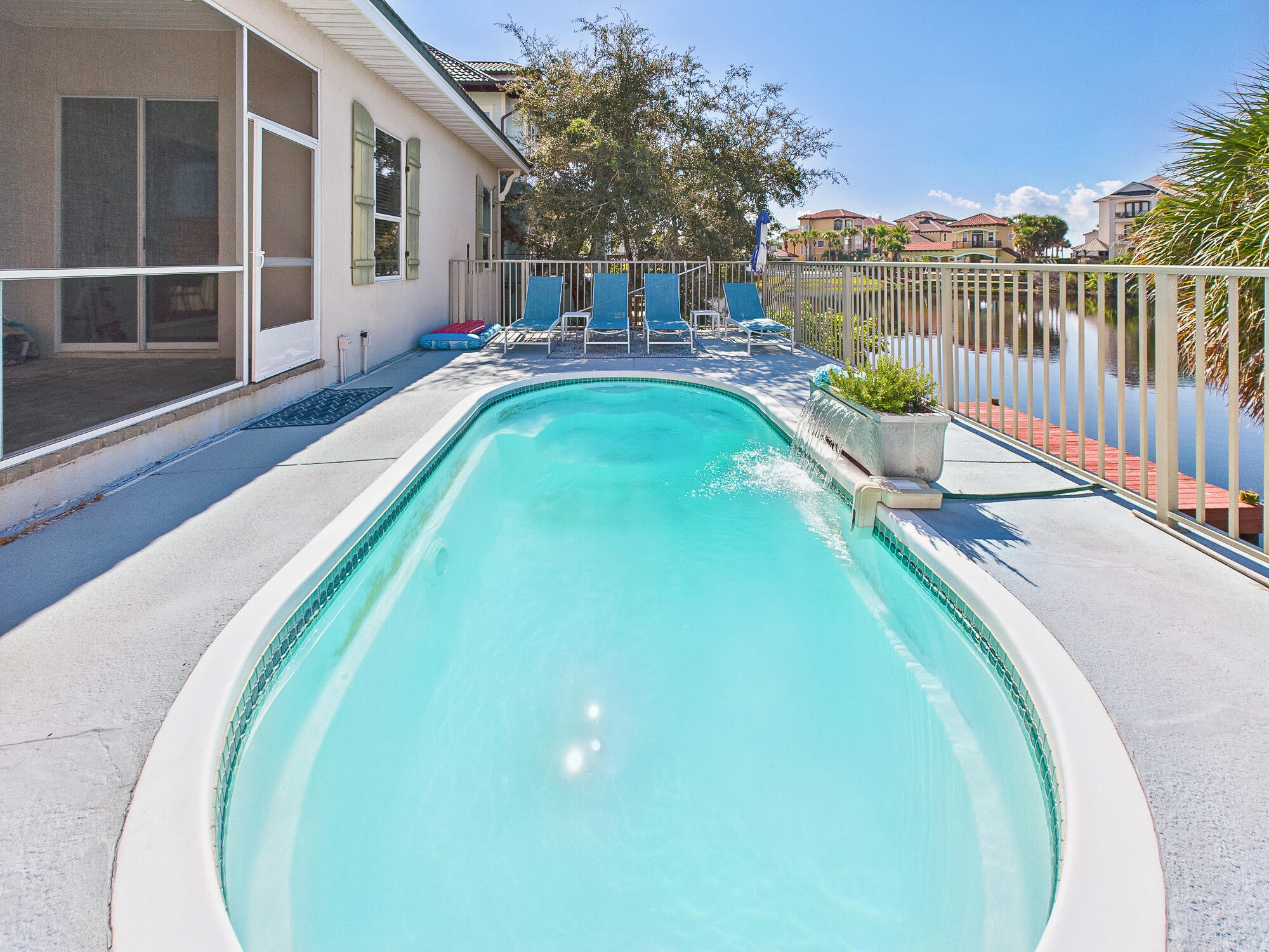 4634 Sunset Pointe Destin, FL 32541 - Photo 50 of 68 a view of a swimming pool with a patio and wooden fence