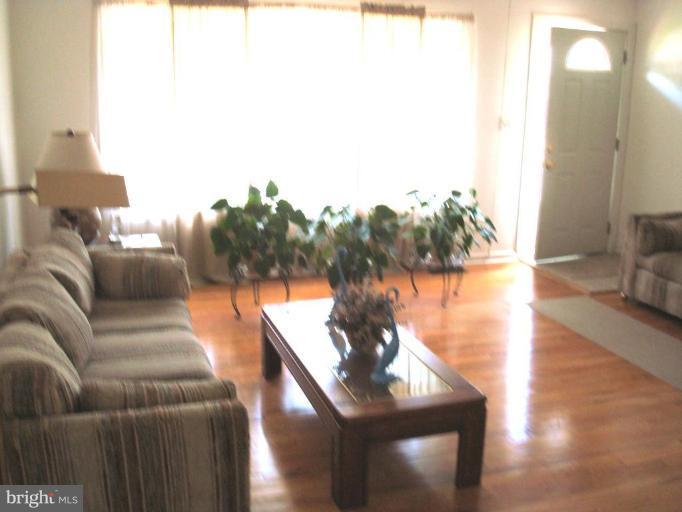 4734 Byron Road Windsor Mill, MD 21244 - Photo 2 of 10 a living room with furniture and a floor to ceiling window