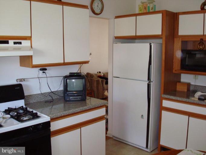 4734 Byron Road Windsor Mill, MD 21244 - Photo 3 of 10 a kitchen with a refrigerator and a sink