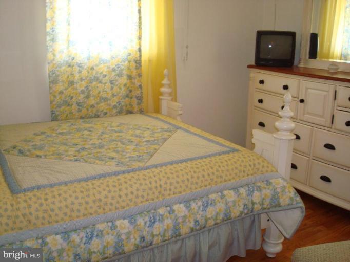 4734 Byron Road Windsor Mill, MD 21244 - Photo 5 of 10 a bed sitting in a bedroom next to a window