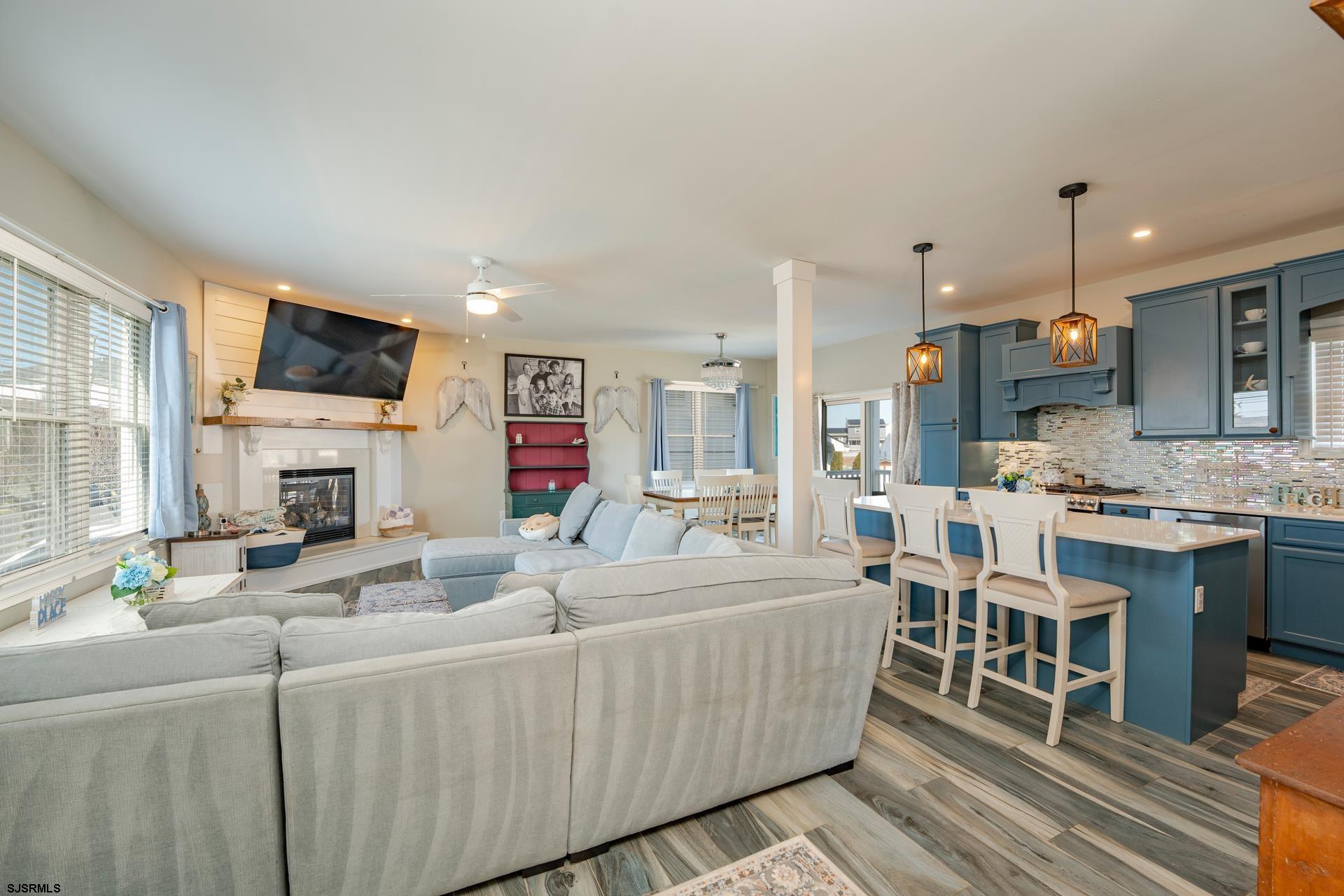 703 Bobby Jones Road Brigantine, NJ 08203 - Photo 8 of 34 a living room with fireplace furniture and a flat screen tv