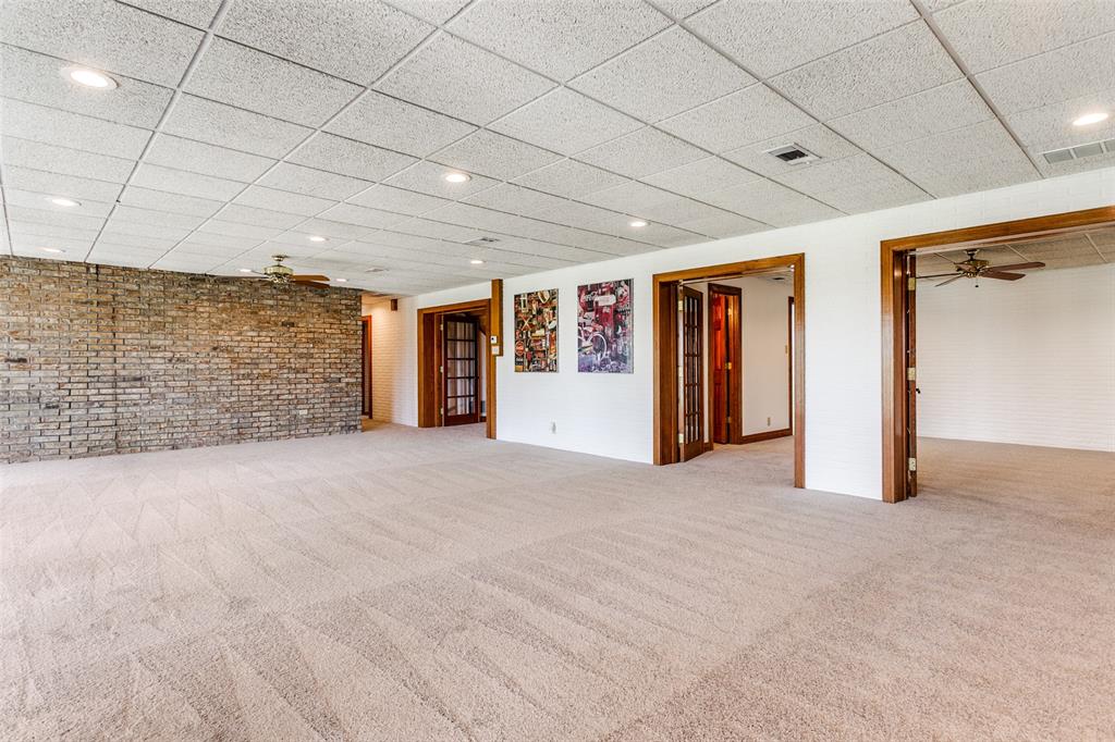 1557 Latigo Hills Road Bartonville, TX 75022 - Photo 25 of 40 Below grade area with ceiling fan, light carpet, brick wall, recessed lighting, and a paneled ceiling