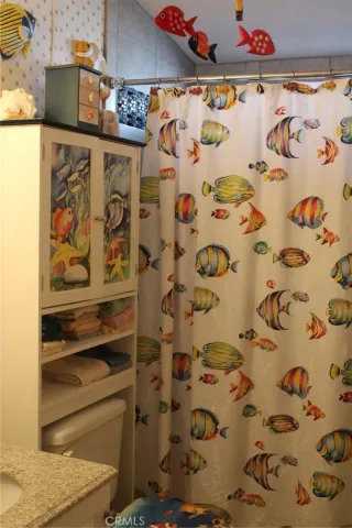 a bathroom with a shower curtain and a sink
