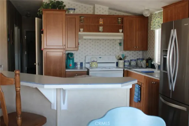 a kitchen with stainless steel appliances a refrigerator and a sink