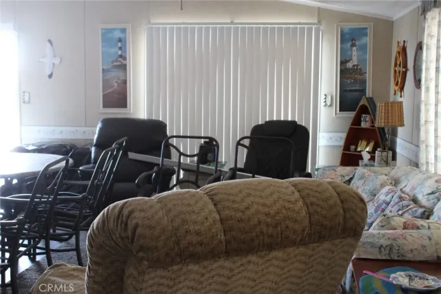 a bedroom with two beds and a chair