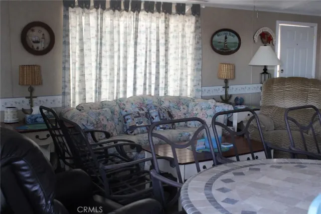 a view of a dining room with furniture and a large window