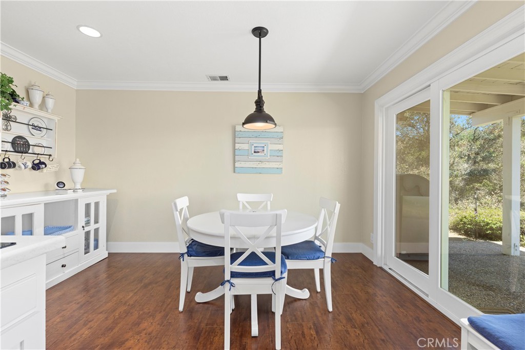 3237 Canonita Drive Fallbrook, CA 92028 - Photo 12 of 55 a dining room with furniture wooden floor a rug and a chandelier