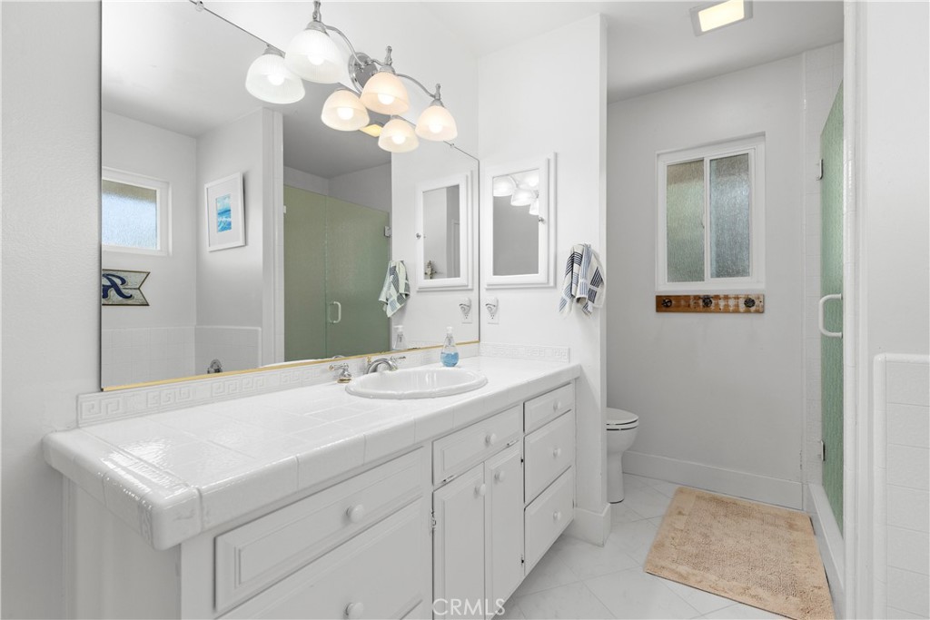3237 Canonita Drive Fallbrook, CA 92028 - Photo 24 of 55 a bathroom with a sink a light fixture and a mirror