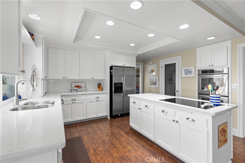 3237 Canonita Drive Fallbrook, CA 92028 - Photo 10 of 55 a kitchen that has a lot of cabinets in it and wooden floors