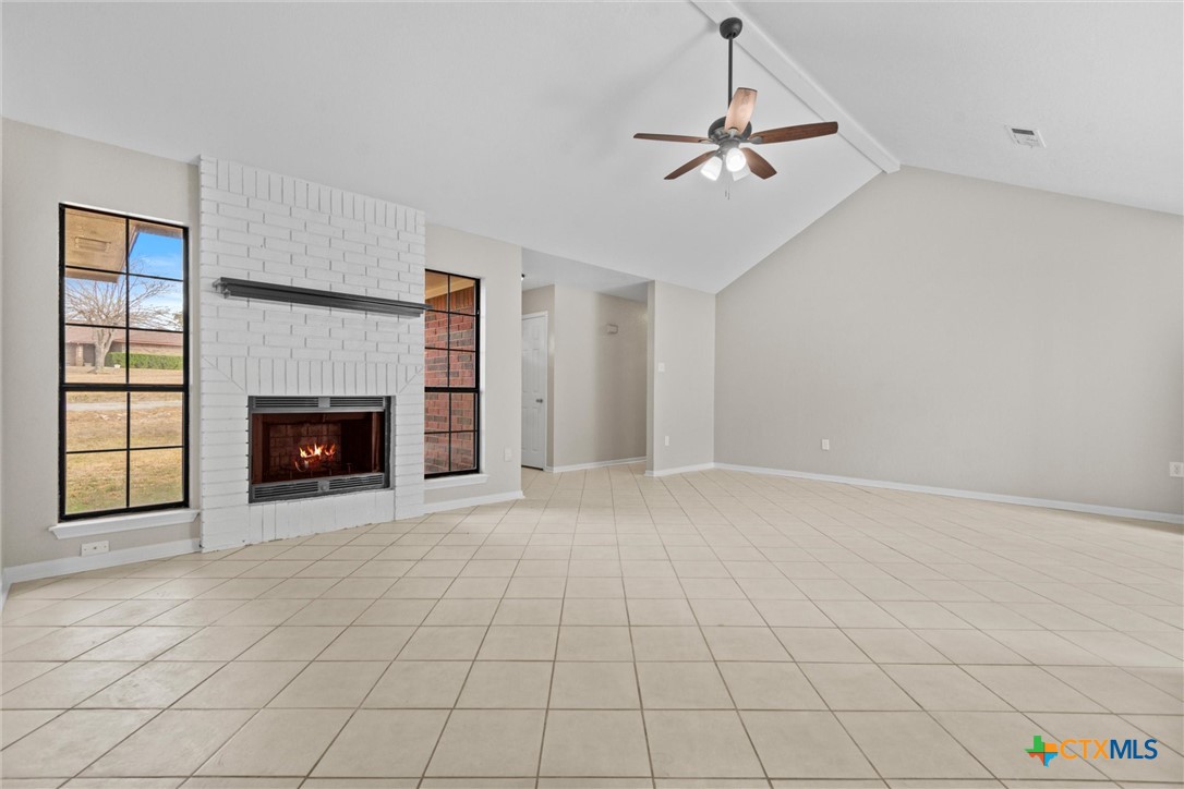 180 County Road 4933 Kempner, TX 76539 - Photo 5 of 24 a view of an empty room with a fireplace and a window